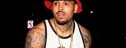 Chris Brown with Red Hat On Smiling