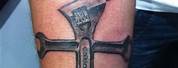 Cross Tattoo On the Shoulder with Wrenches