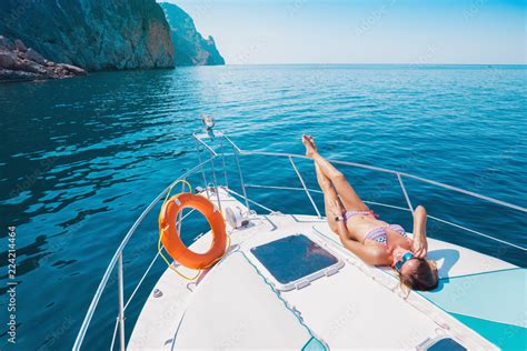 Woman Sunbathing On Yacht